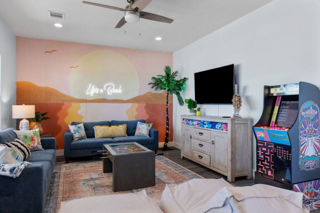 Vibrant entertainment area with games and colorful decor in a Kindred Design styled vacation home.