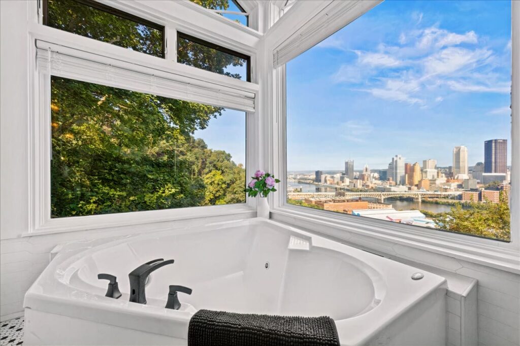 Luxurious bathtub with a stunning view in a vacation rental designed by Kindred Design.